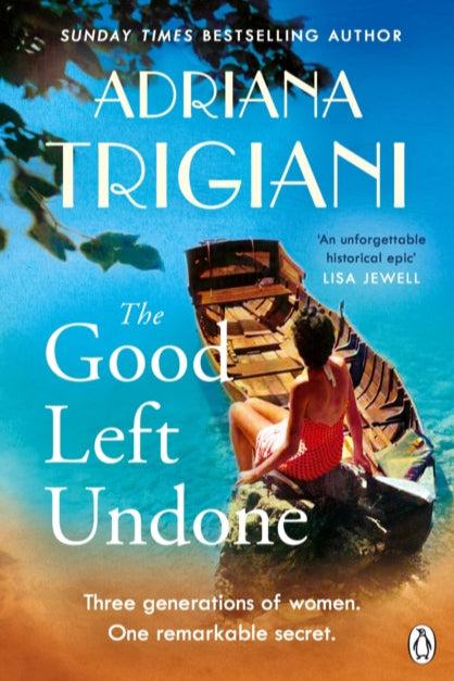 Book cover of 'The Good Left Undone' by Adriana Trigiani with a woman in a boat and blue water.
