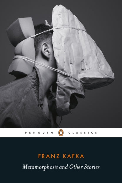 Book cover of 'Metamorphosis and Other Stories' by Franz Kafka with a black and white photo of a person wearing a奇怪的头盔.