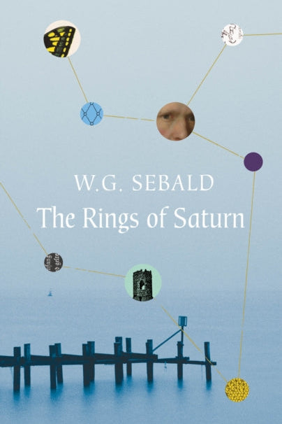 Book cover of 'The Rings of Saturn' by W.G. Sebald with a blue background and celestial design.