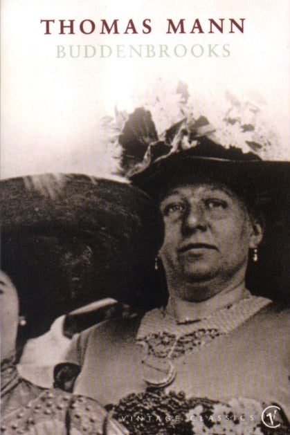 Book cover of 'Buddenbrooks' by Thomas Mann featuring a black and white photograph of a woman in an elaborate hat.