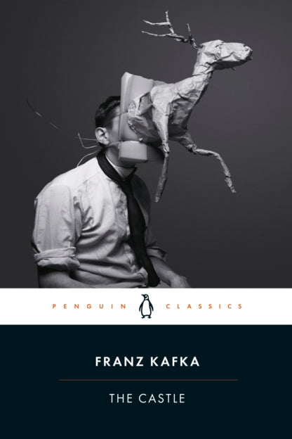 Book cover of 'The Castle' by Franz Kafka with a black and white image of a person holding a paper deer.