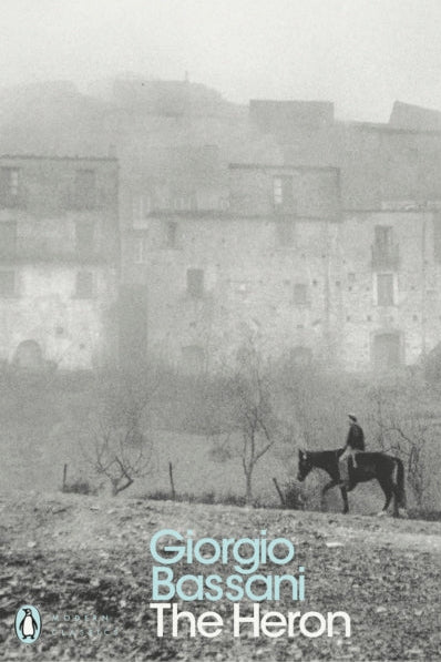 Book cover of 'The Heron' by Giorgio Bassani with a black and white image of a person on horseback in front of a building.