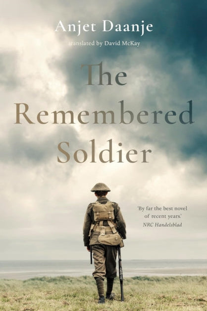 Book cover of 'The Remembered Soldier' with a soldier standing in a field under a cloudy sky.