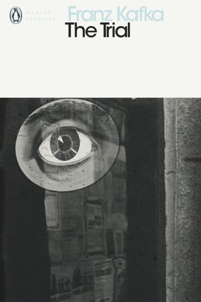 Book cover of 'The Trial' by Franz Kafka with a black and white illustration of an eye.