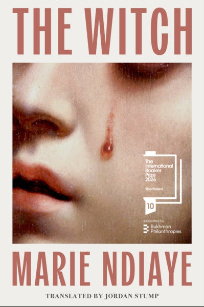 Book cover of 'The Witch' by Marie Ndiaye with a close-up of a face and a red mark.